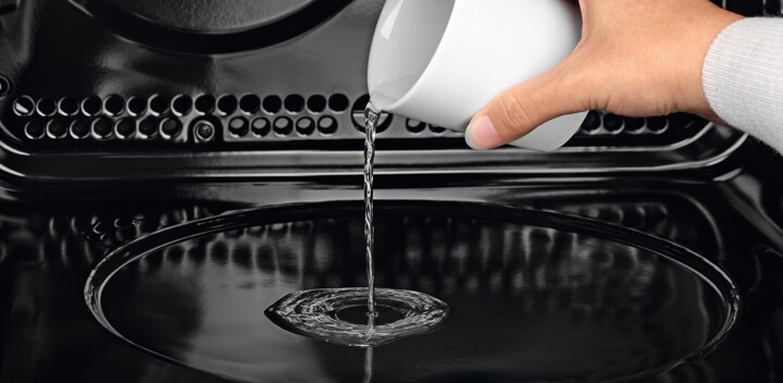 Pouring water into the Multifunction PlusSteam steam oven