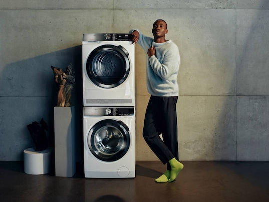Man and stacked appliances