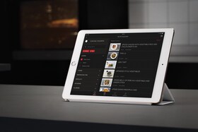 A cook using the My AEG App on their tablet