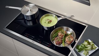 Different sized pans cooking at different selected temperatures
