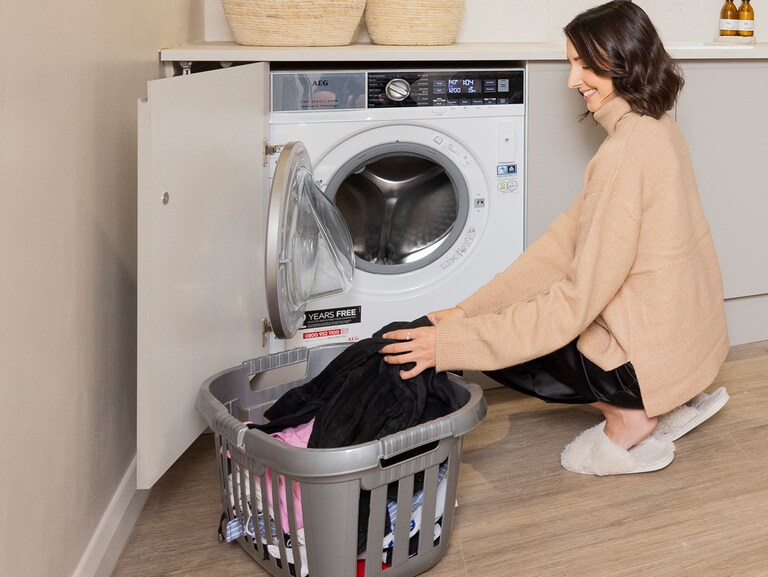 women loading a washing machine