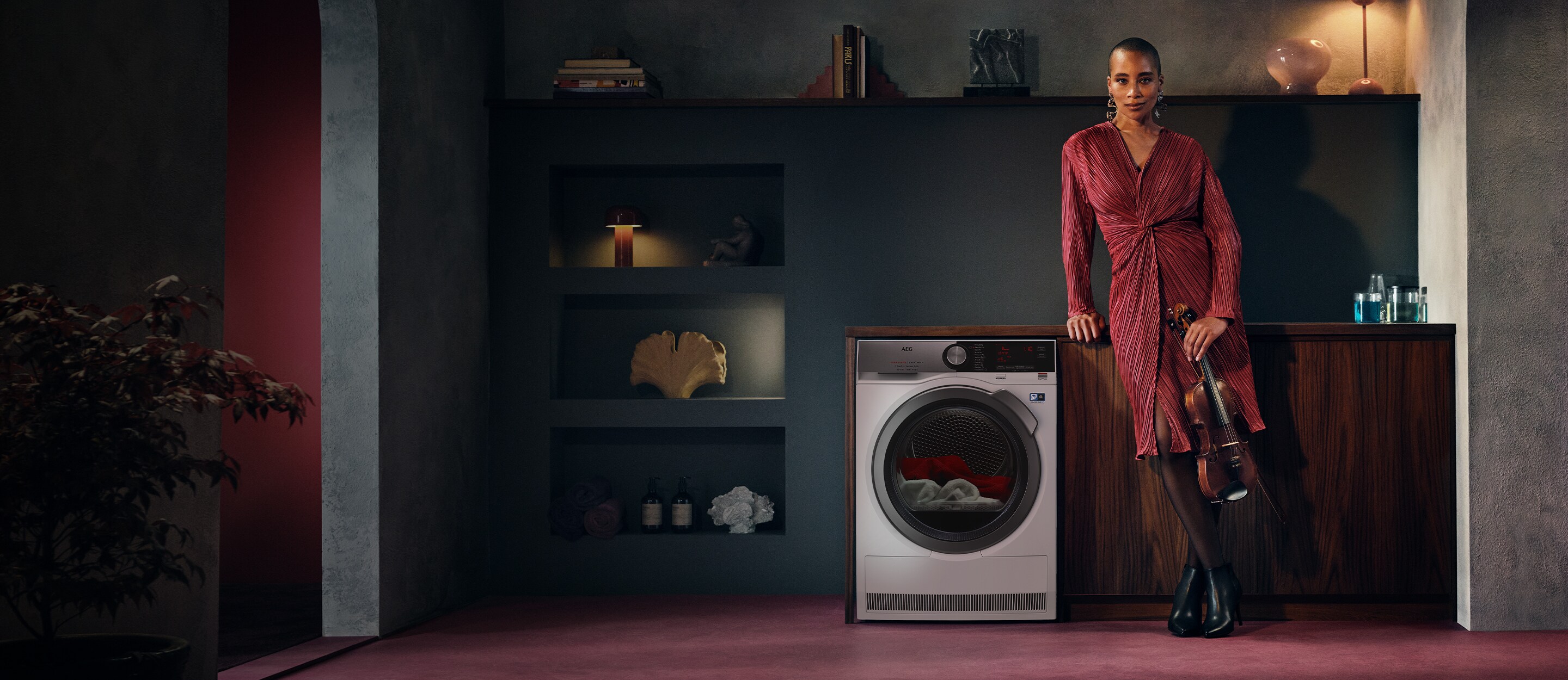 Women standing next to an aeg tumble dryer
