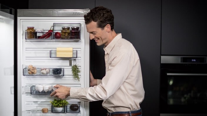 Man opening fridge
