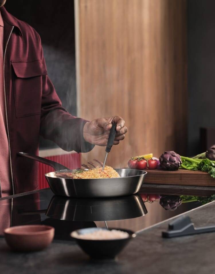 A person is preparing food on an induction hob.