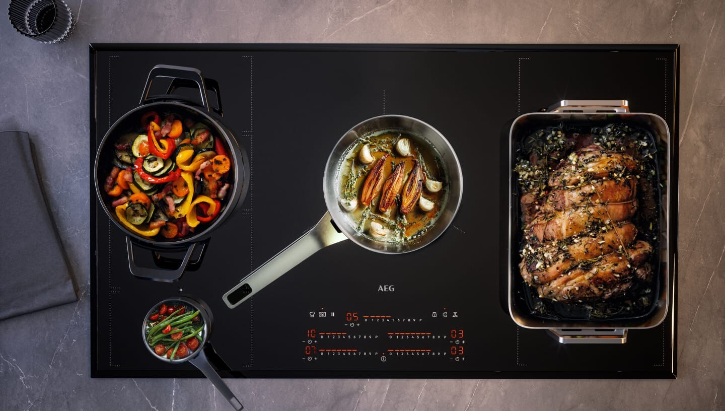 Different types of food are being prepared on an induction hob.