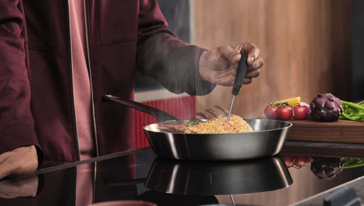 A person is preparing food on an induction hob.