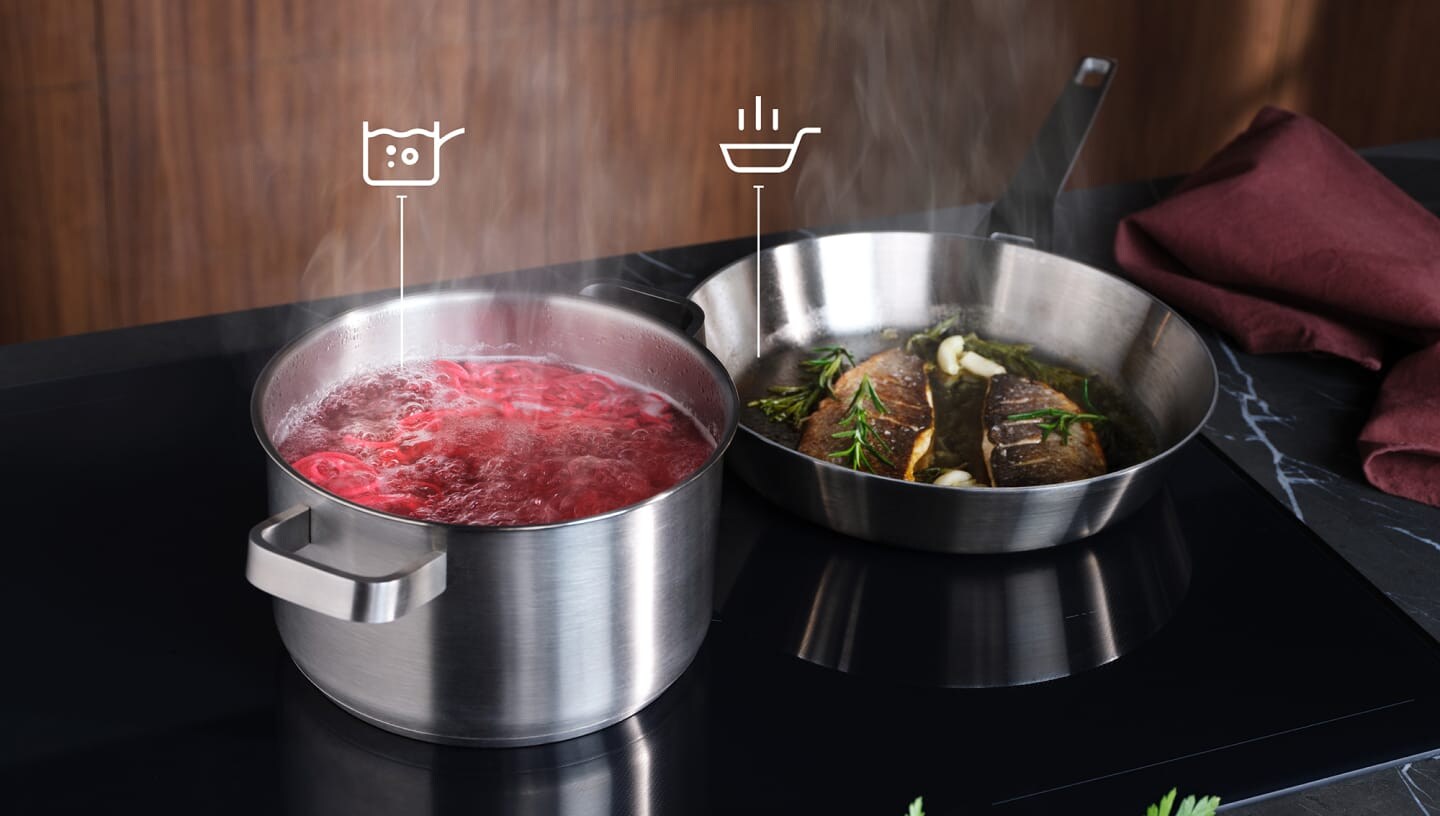Food is being prepared on an induction hob with the SenseBoil and Fry function.