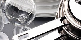 A brightly clean wine glass and set of pans