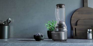 Blender on countertop with blueberry