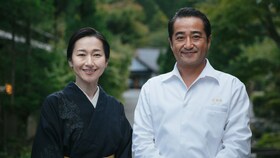 A happy Satchiko & Hisato Nakahigashi standing next to each other