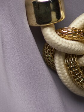 A purple silk top accompanied by jewellery
