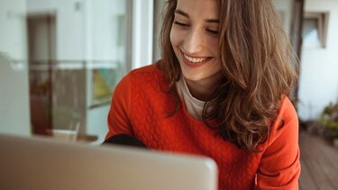 woman smiling looking at computer