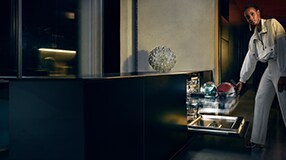 Woman unloading dishwasher