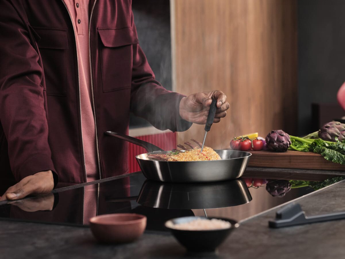 A person is cooking dinner on an induction hob.