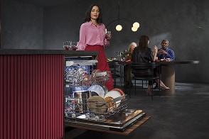 Woman unloading dishwasher