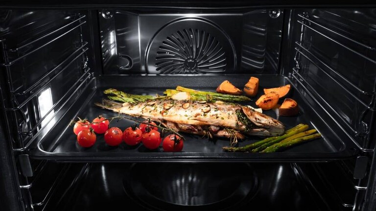 Close-up of steam cooking oven tray.