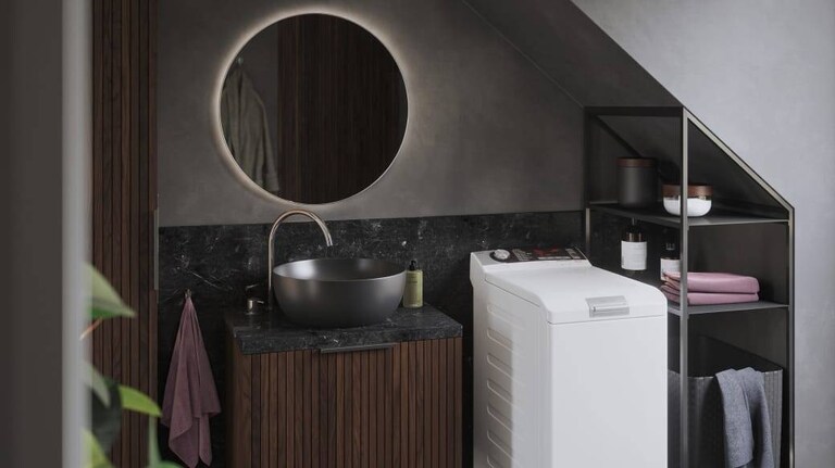 AEG top loader washing machine in a bathroom.