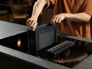 AEG induction hob with extractor in a kitchen.