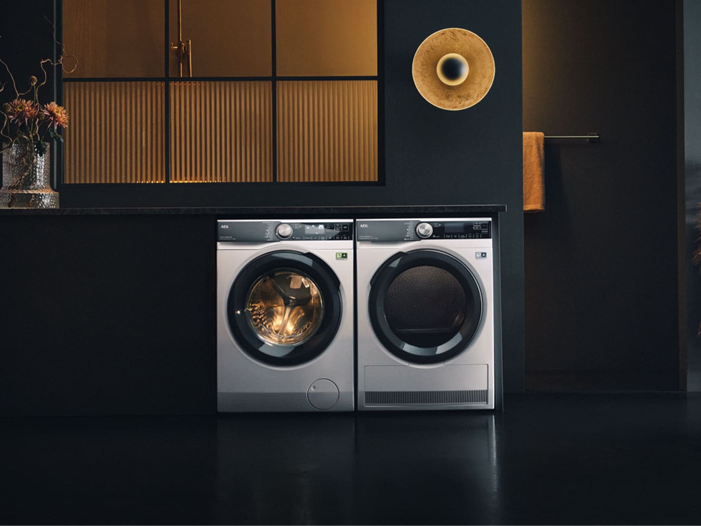 Man standing next to laundry machines.